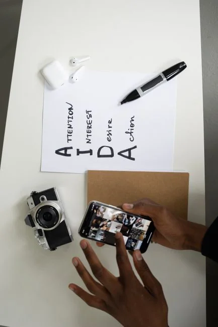 who-we-are Top view of a minimalist setup featuring a tablet and smartphones on a white surface.