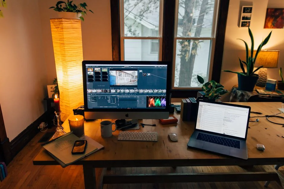 A clean and modern workspace featuring a laptop, tablet, smartphone, and monitor. Ideal for remote work and tech setups.